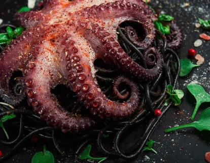 Octopus with black spaghetti, pasta, spices and herbs, top view, no people