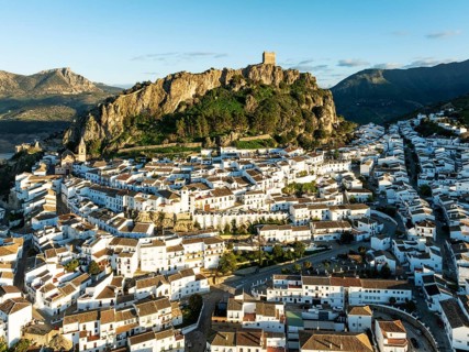 The White Town of Zahara de la Sierra below a Moorish castle. Aerial view. Drone shot. Cádiz