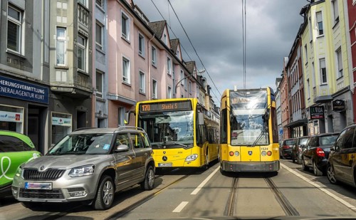 Tram and bus in traffic, on the street Schonnebeckhöfe in Essen-Katernberg, North Rhine-Westphalia,