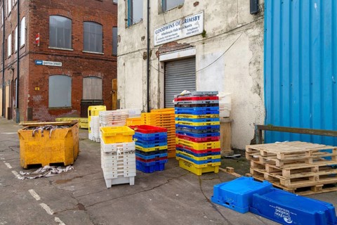 Fish trays and fish carcasses in waste skip. Grimsby docks, north east Lincolnshire, England, UK