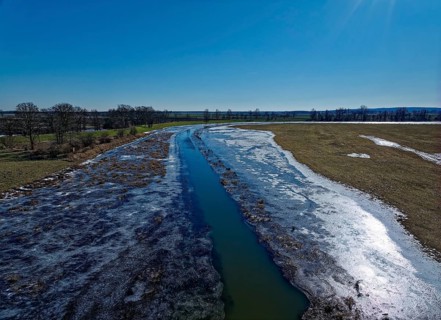 Icy drainage ditch in the landscape of the Havel floodplain in the Altmark. Aerial view. Havelberg,