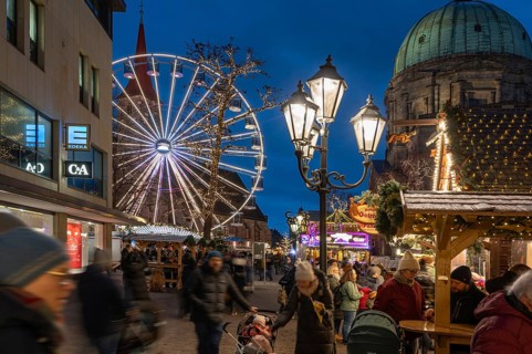 Ferris wheel at the winter village, Christmas market at dusk, St James' Church on the left, St