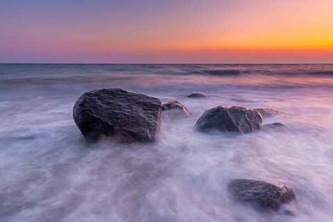 Large boulders in surf at Brodtener Ufer, Brodten Steilufer, cliff in the Bay of Lübeck along the