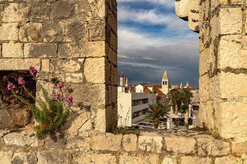 View through the battlements of Kamerlengo Fortress to the old town centre of Trogir, Croatia,