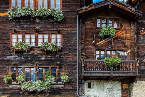 Wooden houses decorated with flowers in the historic village centre, Grimentz, Val d'Anniviers,