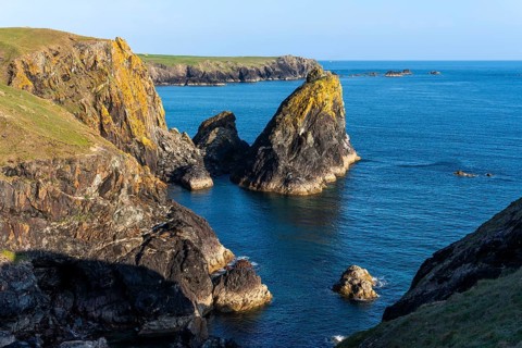 Coastal landscape in Kynance Cove. Evening, golden hour. Kynance Cove, Lizard Peninsula, Cornwall,