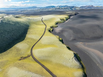Mountain road F206 along moss-covered Laki crater or Lakagígar, series of craters, aerial view,