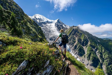 Hiker on hiking trail La Jonction, mountain landscape, view of glacier Glacier de Taconnaz,