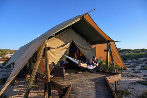 Tourist in a hammock, luxury camp Sal Salis, Cape Range National Park, Ningaloo Reef, near Exmouth,