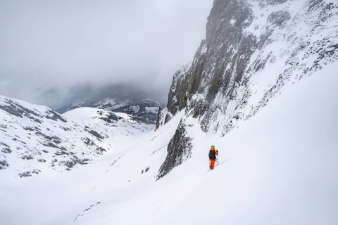 Ski tourer on a steep mountain slope, Snowy mountain landscape, Bernese Alps, Bernese Oberland,