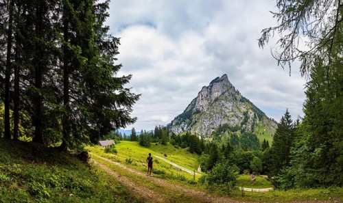 Hiker on the Schartenalm with a view of the Sparber, Osterhorn group, Salzkammergut, Salzburg