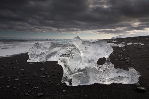 Little icebergs and crushed ice on the black beach at Joekulsarlon glacial lake