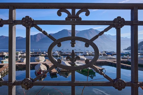 Forged railing, close-up, backlight, lake, mountains, haze, marina, depth of field, Lake Lugano,
