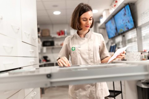 Female pharmacist searching for supplies in the storage room of the pharmacy store