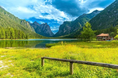 Stunning landscape showing the reflections of the dolomites mountains on the calm waters of lake