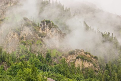 Wisps of mist cover the Karwendel mountains in the Großer Ahornboden nature reserve, Eng Valley,