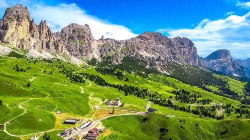 Breathtaking aerial view of the scenic gardena pass in the dolomites, showcasing winding roads,