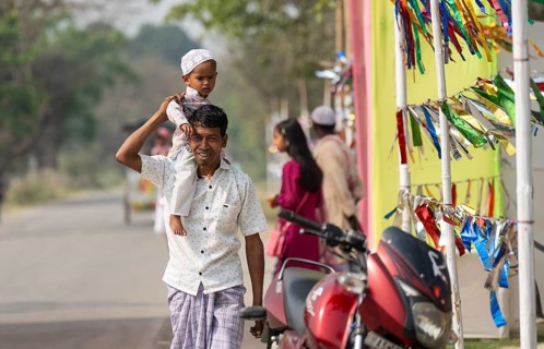 KAYAKUCHI, INDIA - MARCH 31: Muslim man with his children arrives to perform Eid al-Fitr prayer at