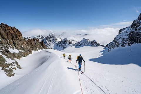 Ski tourer with rope, rope team on the Vadret da Porchabella glacier on the ascent to the summit of