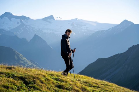 Hiker enjoying the mountain panorama in the morning, Venediger group, behind Dreiherrenkopf,