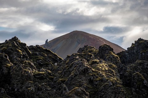 Lava field in front of colourful rhyolite mountain Brennisteinsalda, volcanic landscape, erosion