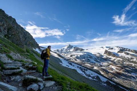 Mountaineer in front of high alpine mountain landscape, summit of the Aiguille de Chardonnet and