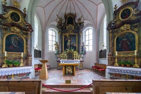 Parish church of St Sebastian with richly decorated altar, statues of saints and paintings, framed