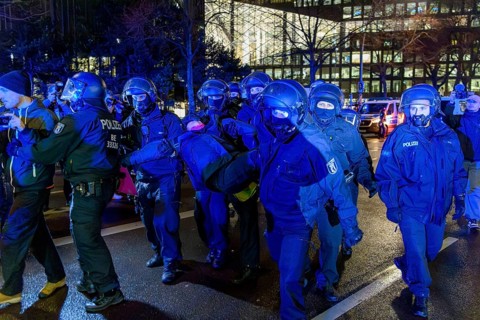 Police clear the protests in front of the Axel Springer skyscraper against the World Economic