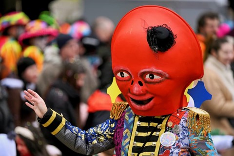 Person dressed up as a red mascot at the Wey guild on Rose Monday, Güdismäntig, Lucerne Carnival