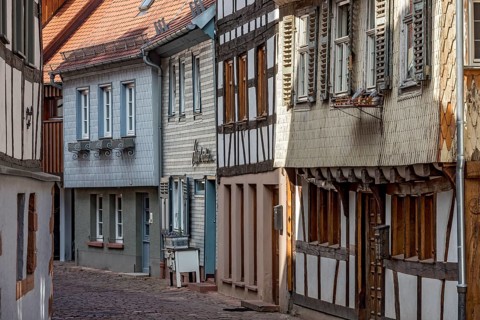 Row of houses with old half-timbered houses and clapboard houses, wooden shingles in pastel