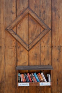 Books to give away on a shelf on a wooden wall, Riegel am Kaiserstuhl, Baden-Württemberg, Germany,