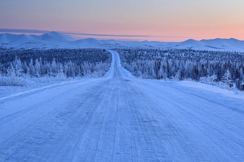 Snow-covered gravel road, highway, ice, snow, cold, mountain landscape, winter, morning mood,