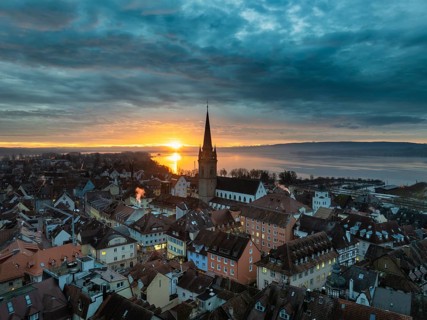 Aerial view of an atmospheric sunrise over the town of Radolfzell on Lake Constance with the