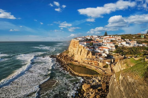 Scenic view of the seaside Azenhas do Mar fishing village on cliff on Atlantic ocean coast,