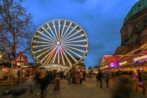 Ferris wheel at the winter village, Christmas market at dusk, St Elisabeth's Church on the right,