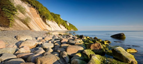 Chalk cliffs and boulders on the Baltic Sea in spring, Königsstuhl in the background, fresh