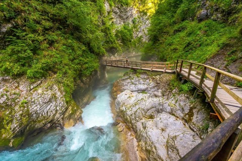 Wooden tourist pathway over the radovna river flowing through the vintgar gorge near bled in