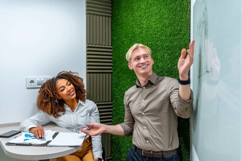 Two managers analyzing data and discussing strategy during a meeting in a modern coworking office
