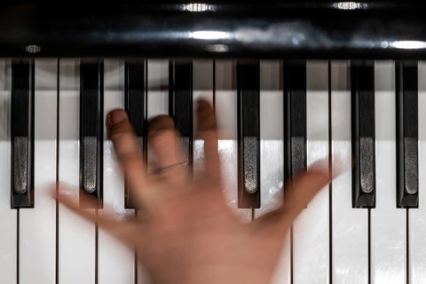 Hand of a young pianist playing on the keyboard of a Steinway & Sons grand piano, Stuttgart,