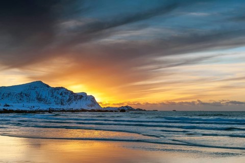 Sunset in winter at Skagsanden, stones on the beach at Flakstad, Flakstadøy, Lofoten, Nordland,