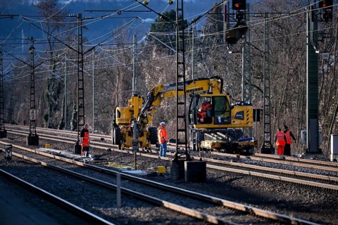 Labourers working with Liebherr A922 Rail Litronic and Kuhnle RR14 EVO 3 Rail two-way working