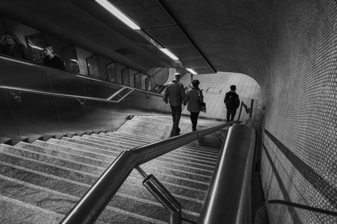 Black and white photo of an urban underground station with stairs and people, Stuttgart, Germany,