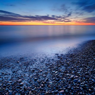 Pebbles in the water on the shore of the Baltic Sea at dusk after sunset, Weststrand Darß,