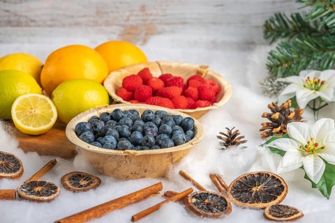 Healthy fruit and berries, white background, Christmassy decoration