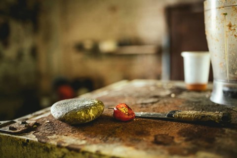 Knife, stone and chilli pepper in a kitchen in a dwelling in Petare, Venezuela, South America