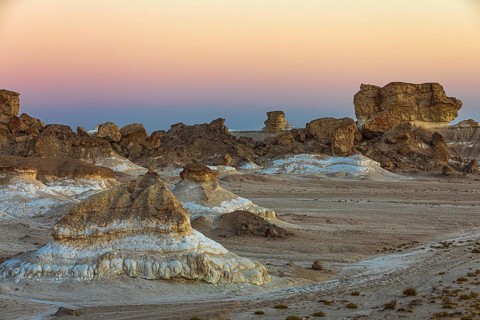 Eroded rock formations on a fossilised reef edge, at blue hour, Huqf stone desert, Arabian