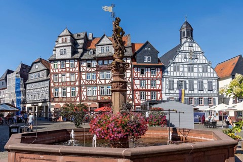 Kump, medieval market fountain, fountain figure market fountain man with market flag, sandstone
