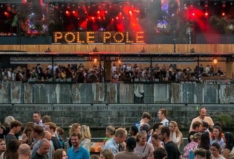 Spectators on grandstand at the Graslei watching Pole Pole podium during Gentse Feesten, Ghent city