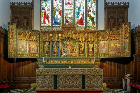 Elaborately carved gilt altar reredos screen 1938, church of Saint John the Baptist, Peterborough,