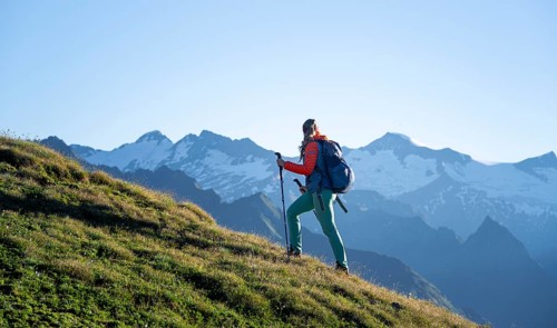 Hiker enjoying the mountain panorama in the morning, Venediger group, behind Dreiherrenkopf,
